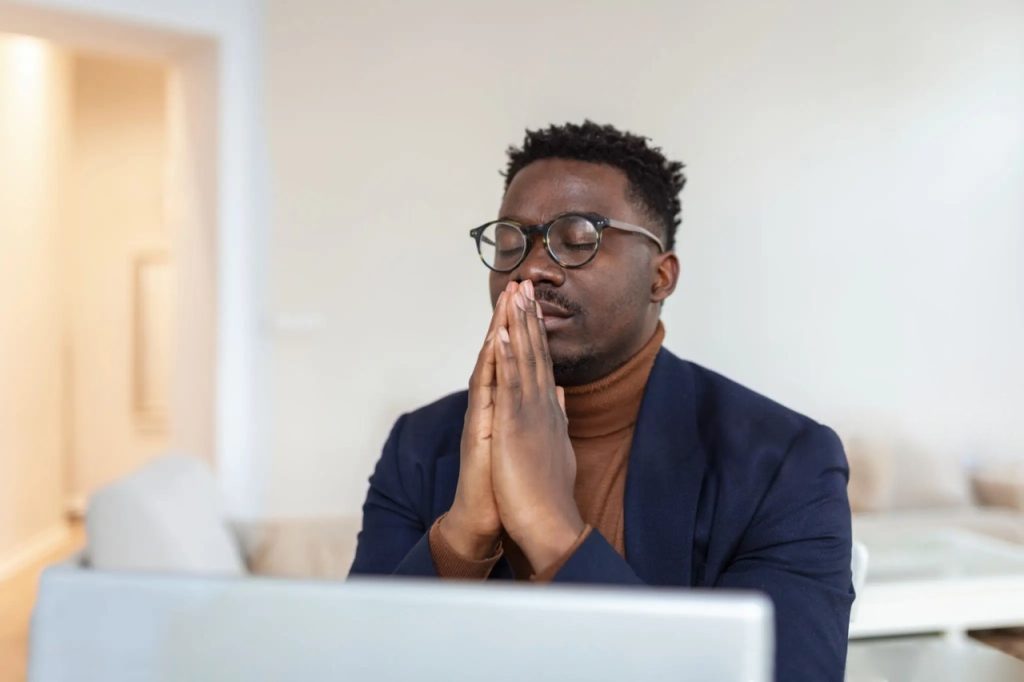 Calm focused person praying before work